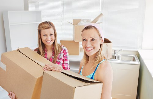 Careful unloading of household items during a West Kensington move