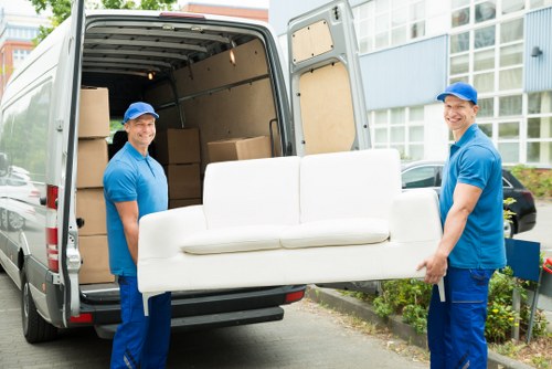 Man with van pricing for a move in West Kensington residential street
