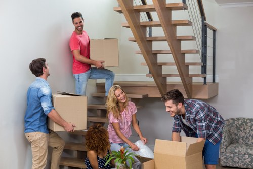 Furniture pick-up team handling bulky items in a West Kensington flat