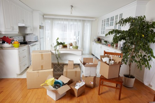 Removal workers transporting items through a West Kensington apartment building