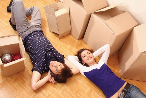 Student furniture and boxes being carried from a shared house in West Kensington