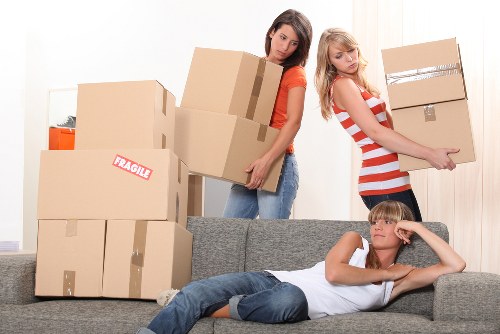 Packed boxes and furniture ready for house removals in a West Kensington flat